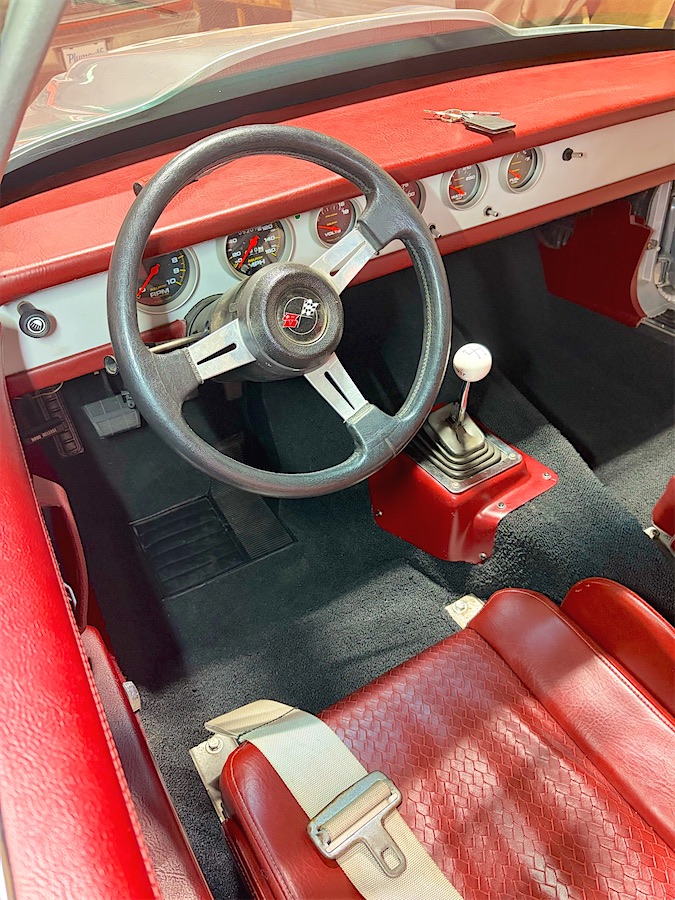 Custom fitted carpet in a classic car with a red interior